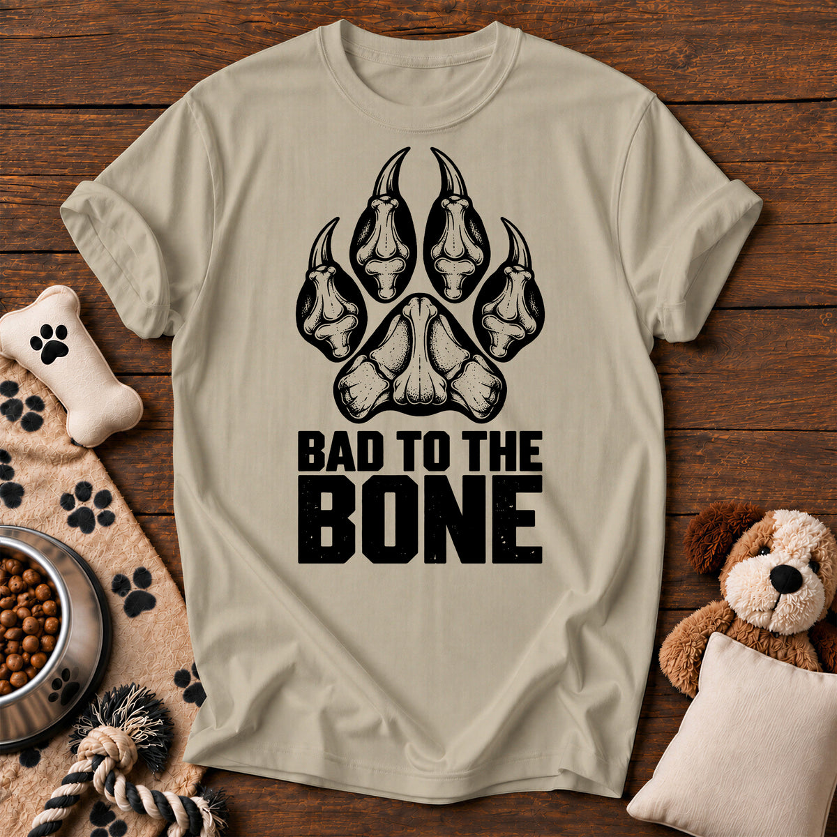 Bad to the Bone Dog Paw Tee — funny dog t-shirt in Sandstone, Comfort Colors 1717 flat lay