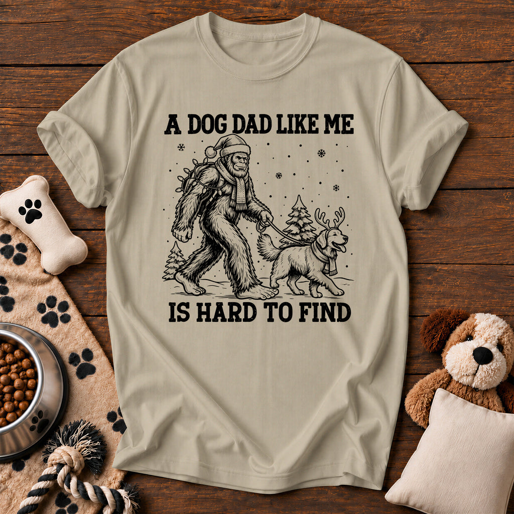 Bigfoot Dog Dad Christmas Tee — funny dog t-shirt in Sandstone, Comfort Colors 1717 flat lay