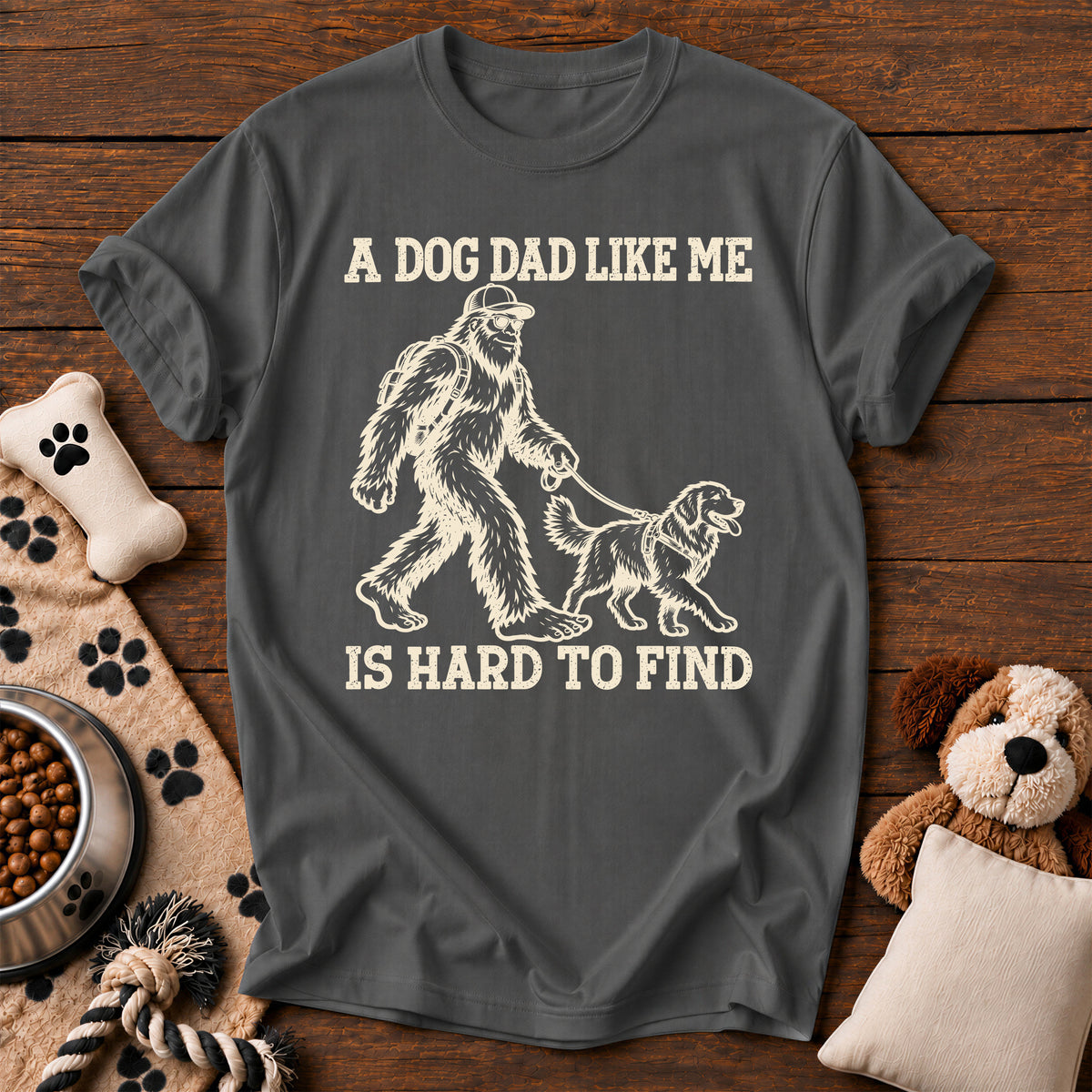 Bigfoot Dog Dad Tee — funny dog t-shirt in Pepper, Comfort Colors 1717 flat lay